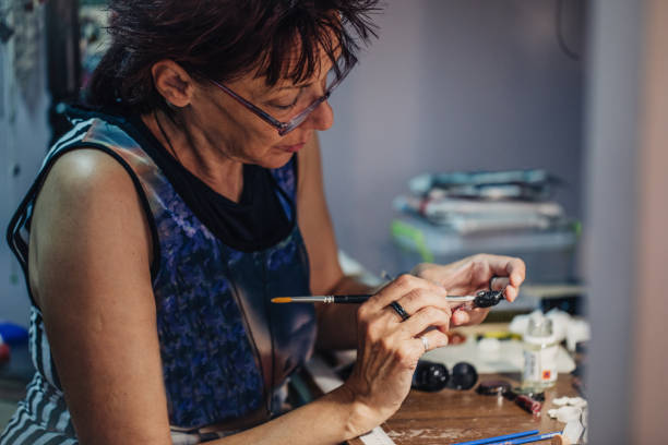 istock Woman making jewelry 994425150