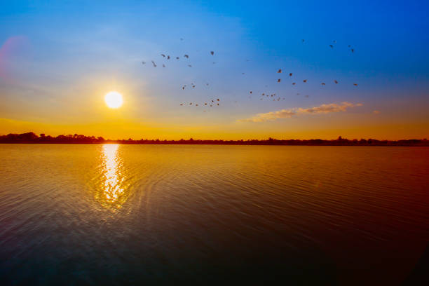Sunset sky background. Dramatic gold sunset sky with evening sky clouds over the sea. Stunning sky clouds in the sunset. Sky landscape. Panoramic sky view