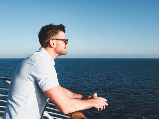 istock Attractive guy on the deck of a cruise ship 994435378