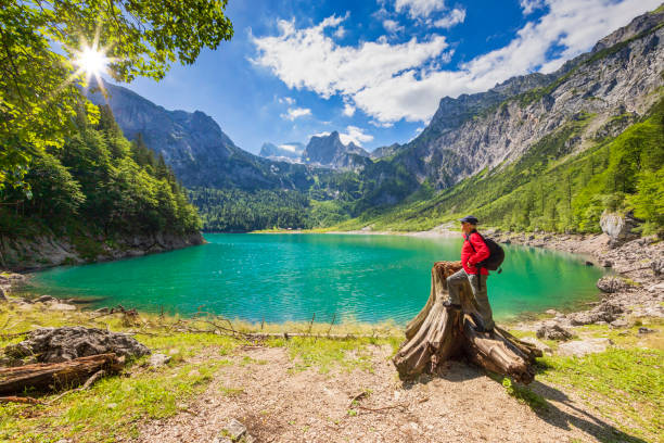 istock Hiker at Gosausee with dachstein view 994435380
