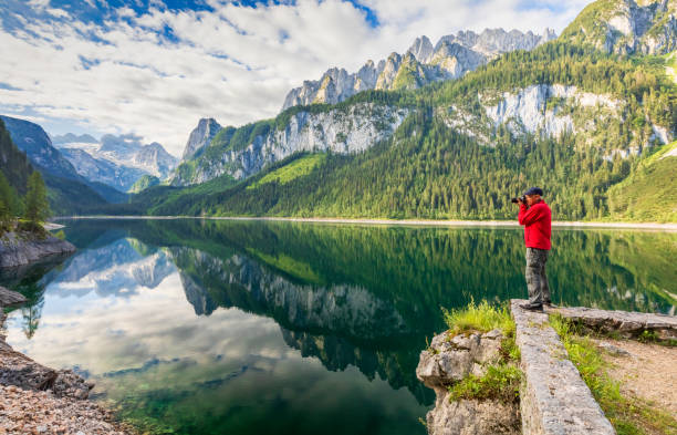 istock Photographer at Gosausee with dachstein view - European Alps 994435530