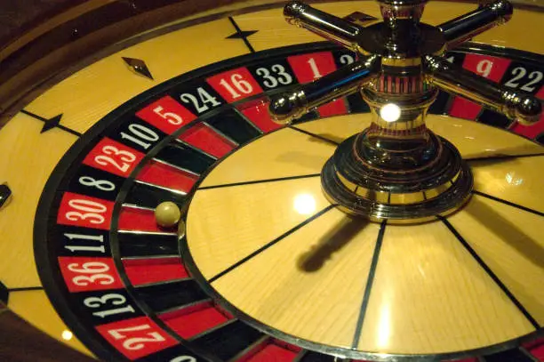Golden Casino roulette, poker game, dice game, poker chips on a gaming table.
