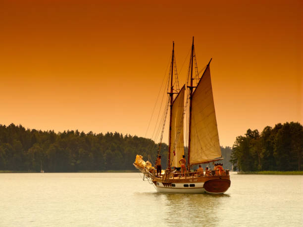 Piaski, Warmian-masurian province, Poland. Gaff schooner on the Beldany lake. Masurian Lakes District. Sepia color graduated filter in use.