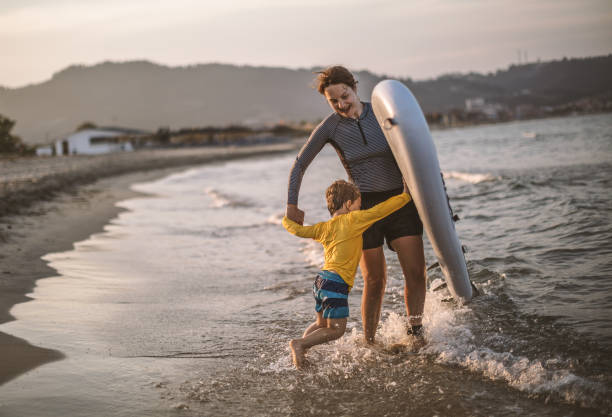 istock Family surfers at the beach 994464972