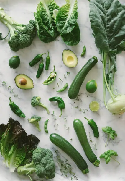 Photo of Fresh spring vegetables on a marble background