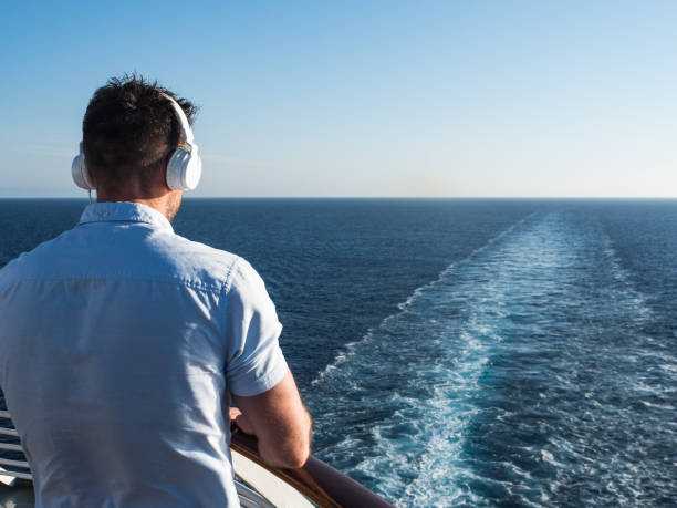 istock Man on the deck of a cruise ship 994471346