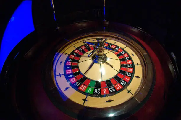 Golden Casino roulette, poker game, dice game, poker chips on a gaming table.