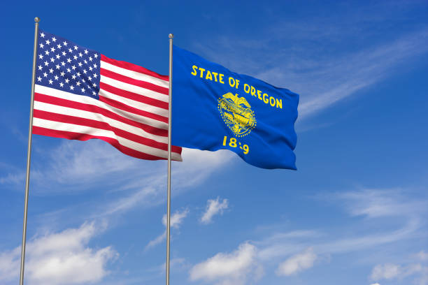 istock USA and Oregon flags over blue sky background. 3D illustration 994476456