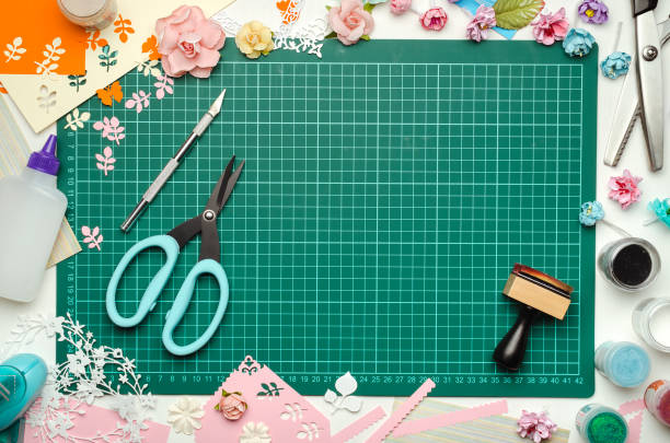 istock The cutting mat is surrounded by paper flowers, paper, tools and scrapbooking materials 994479426