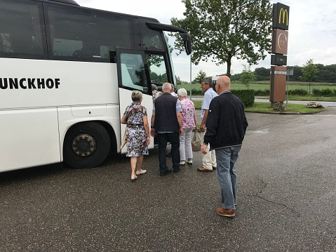 Brunssum, the Netherlands, - June 12, 20184. Group of Seniors step out of the bus during a trip in the city.