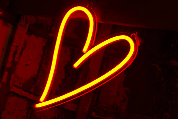 istock neon sign forming the heart yellow neon 994509832