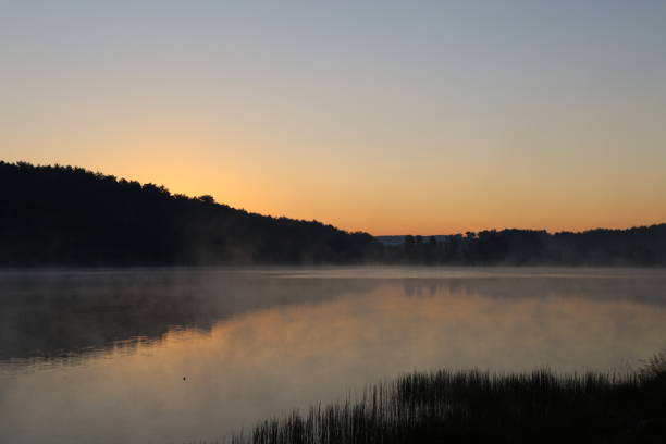 Sunrise over misty lake