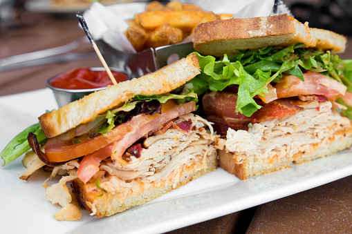 Delicious turkey club sandwich on toast with bacon, lettuce and tomato.