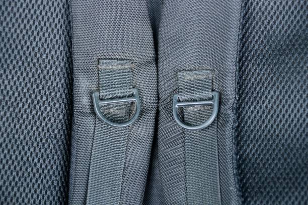 Black harness with plastic carabiners on a backpack