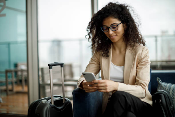 istock Businesswoman using mobile phone at rooftop cafe 994518308