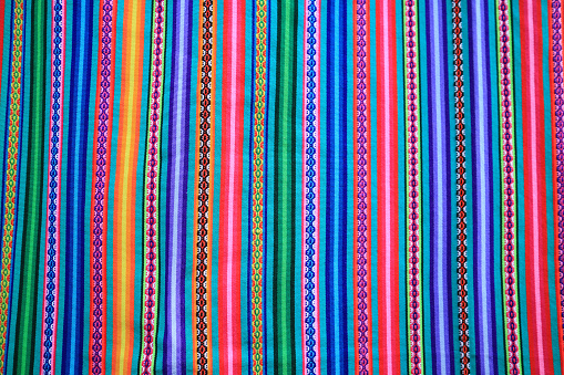 Multi color vivid tone stripe of Peruvian fabric for background, banner or texture