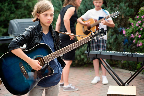 istock Boy's band getting ready to play in family driveway. 994549332