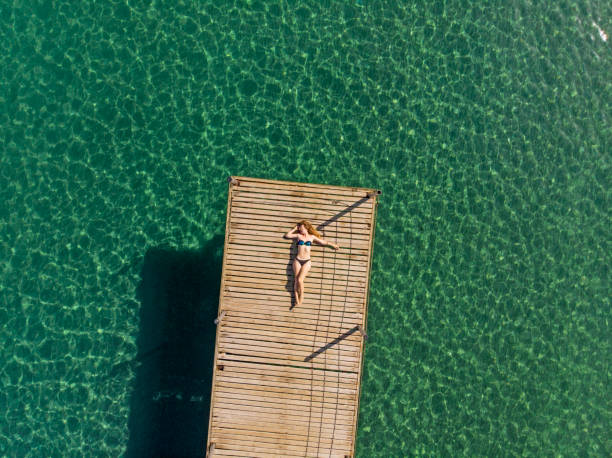 istock Young Woman Relaxing at The Sea 994551698