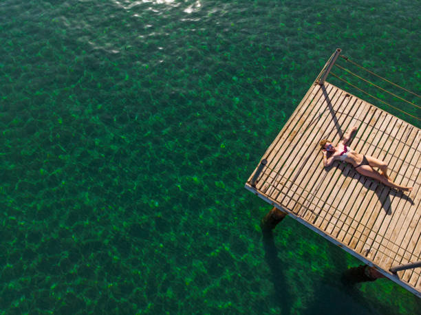 istock Young Woman Relaxing at The Sea 994551748