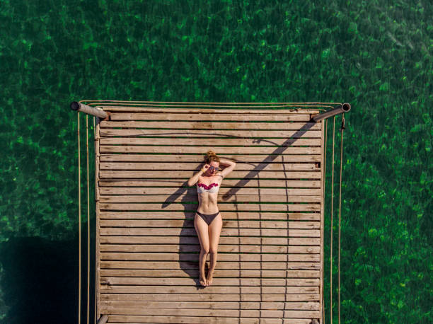 istock Young Woman Relaxing at The Sea 994551756