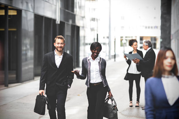 istock Business people walking downtown business district 994576202