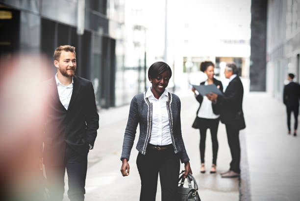 istock Business coworkers walking downtown business district 994578492