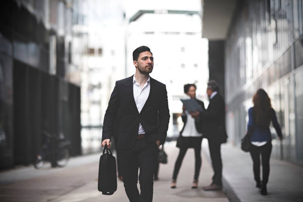 istock Businessman walking downtown business district 994589186