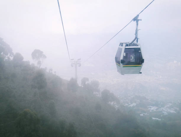 Metrocable de Medellín (cable car) going to Arví Park Medellin metrocable cabin (cable car) going to Arví Park, a cloudy day, with a view of the cable and the towers. Inclusive mass transportation. Medellin Colombia. metro medellin stock pictures, royalty-free photos & images