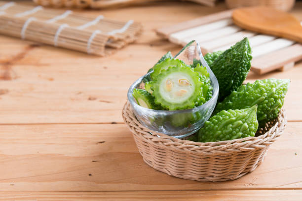 Balsam apple, Balsam pear, Bitter cucumber , Bitter gourd , Stuffed bitter gourd, karela on wood background stock photo