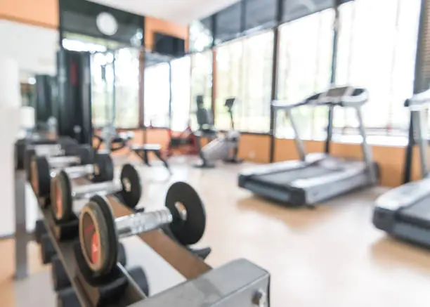 Photo of Blur gym background fitness center or health club with blurry sports exercise equipment for aerobic workout and bodybuilding