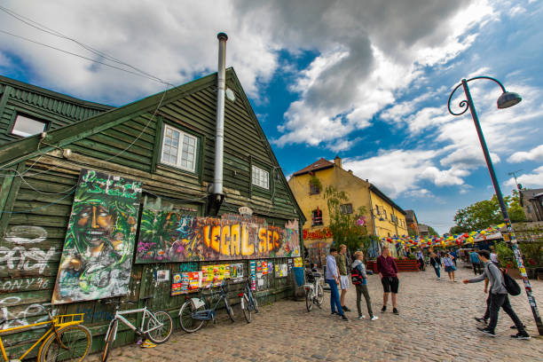 Prague, Czech Republic - June 27, 2016: Young man painting the famous Lennon graffiti wall in old town of Prague, Czech Republic