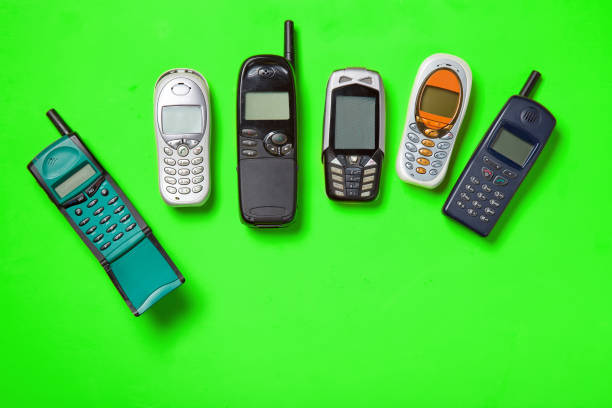istock Old mobile phones on green background. 994631978