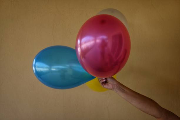 istock colorful balloons in the hand 994636648