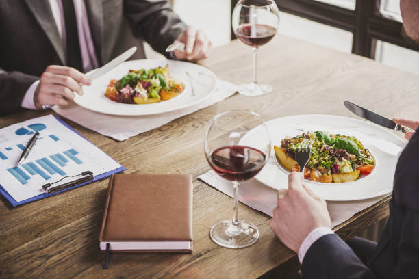 Close up. Two Businessmen Have Lunch with Wine.