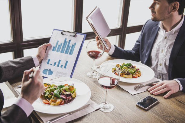 istock Two Businessmen Have Lunch with Wine in Restaurant 994637214