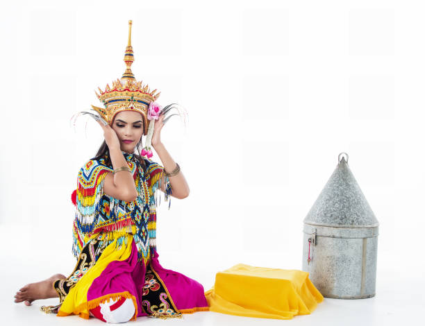 istock The lady in Southern thai classical dancing suit is posing on white background.she is putting the headdress on her head, 994637606