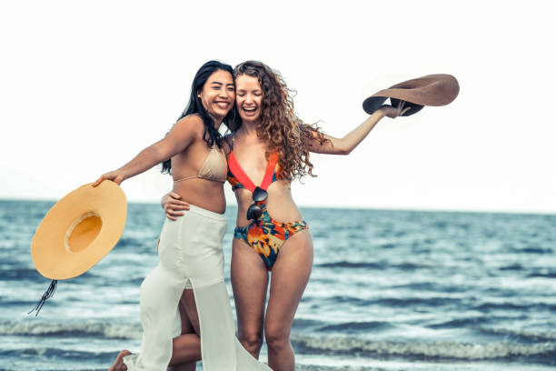 istock Happy women dance on sand beach in summer. 994646212