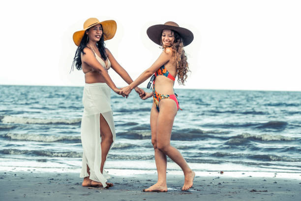 istock Happy women dance on sand beach in summer. 994646214