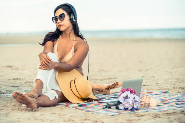 istock Plus size young woman sitting on the beach. 994646230