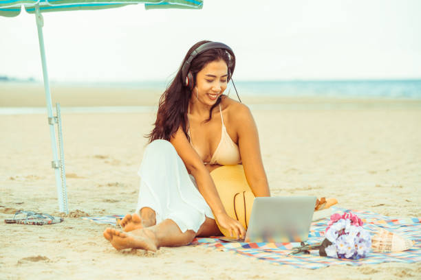 istock Plus size young woman sitting on the beach. 994646232