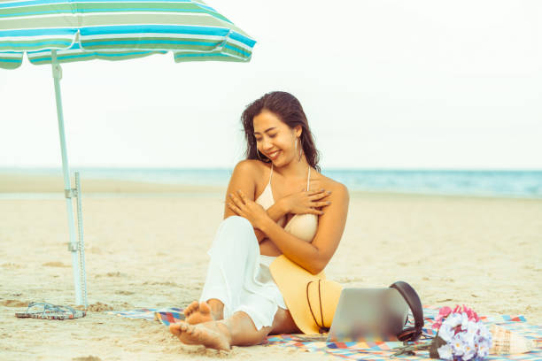 istock Plus size young woman sitting on the beach. 994646244