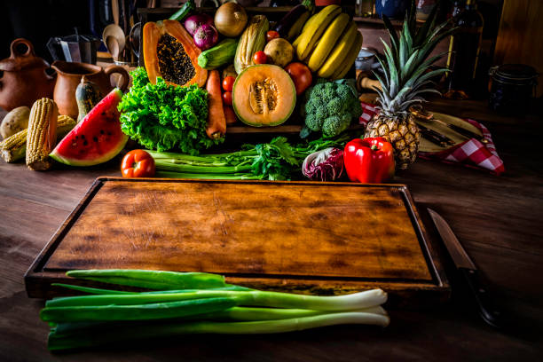 istock Making a vegan salad in rustic kitchen with assorted organic vegetables. Natural lighting 994648406