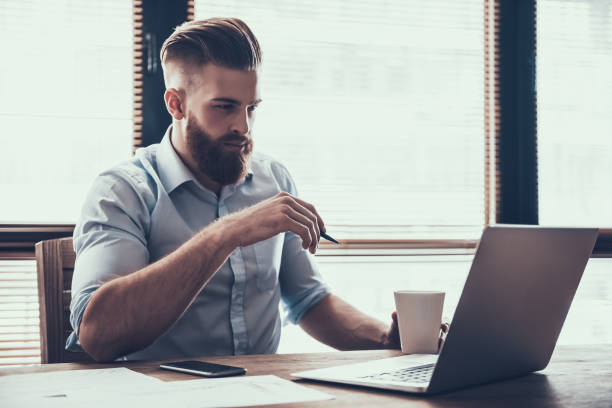 istock Young Handsome Businessman Working with Laptop. 994648752