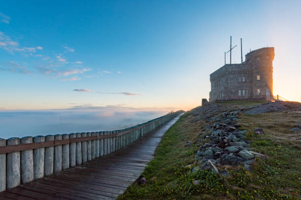 Signal Hill National Historic Site in fog St. John's, NL Canada - June 16, 2018: Signal Hill National Historic Site in fog. Signal Hill recalls the town’s historic past and communications triumph, as well as offering coastal hikes and colourful performances against sweeping views overlooking the Atlantic. st. johns newfoundland photos stock pictures, royalty-free photos & images