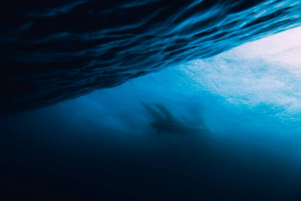 istock Wave is underwater and surfer. Wave crashing on beach 994682974
