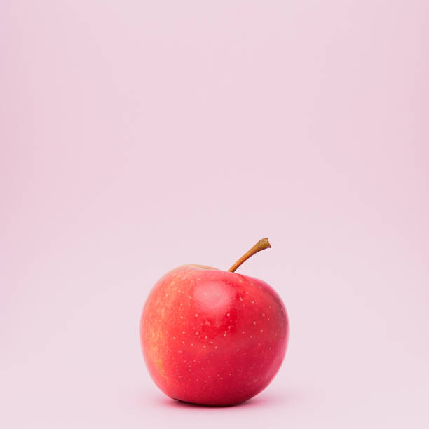 istock A  fresh ripped red apple isolated on pink background. 994691960