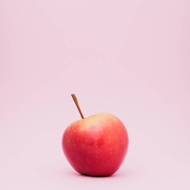 istock A  fresh ripped red apple isolated on pink background. 994691984