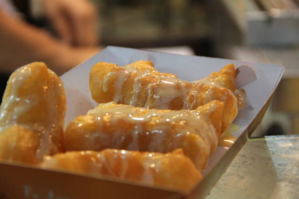 istock deep fried dough stick with sweetened condensed milk topping 994692780