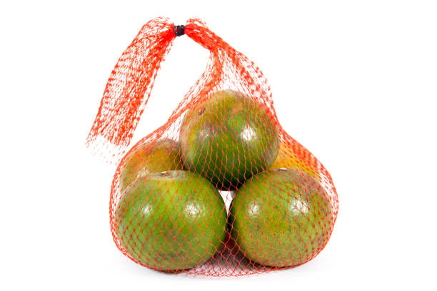 istock Closeup orange fruit in carry net bag isolated on white background 994695224