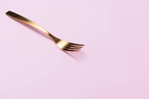 istock A gloden folk isolated on pink background with negative space. 994707750